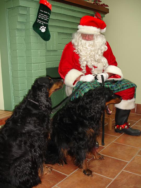 crgordons_30.jpg - Jazzy and Heidi with Santa Claus. Heidi is telling Santa how good she has been and what she wants for Christmas.